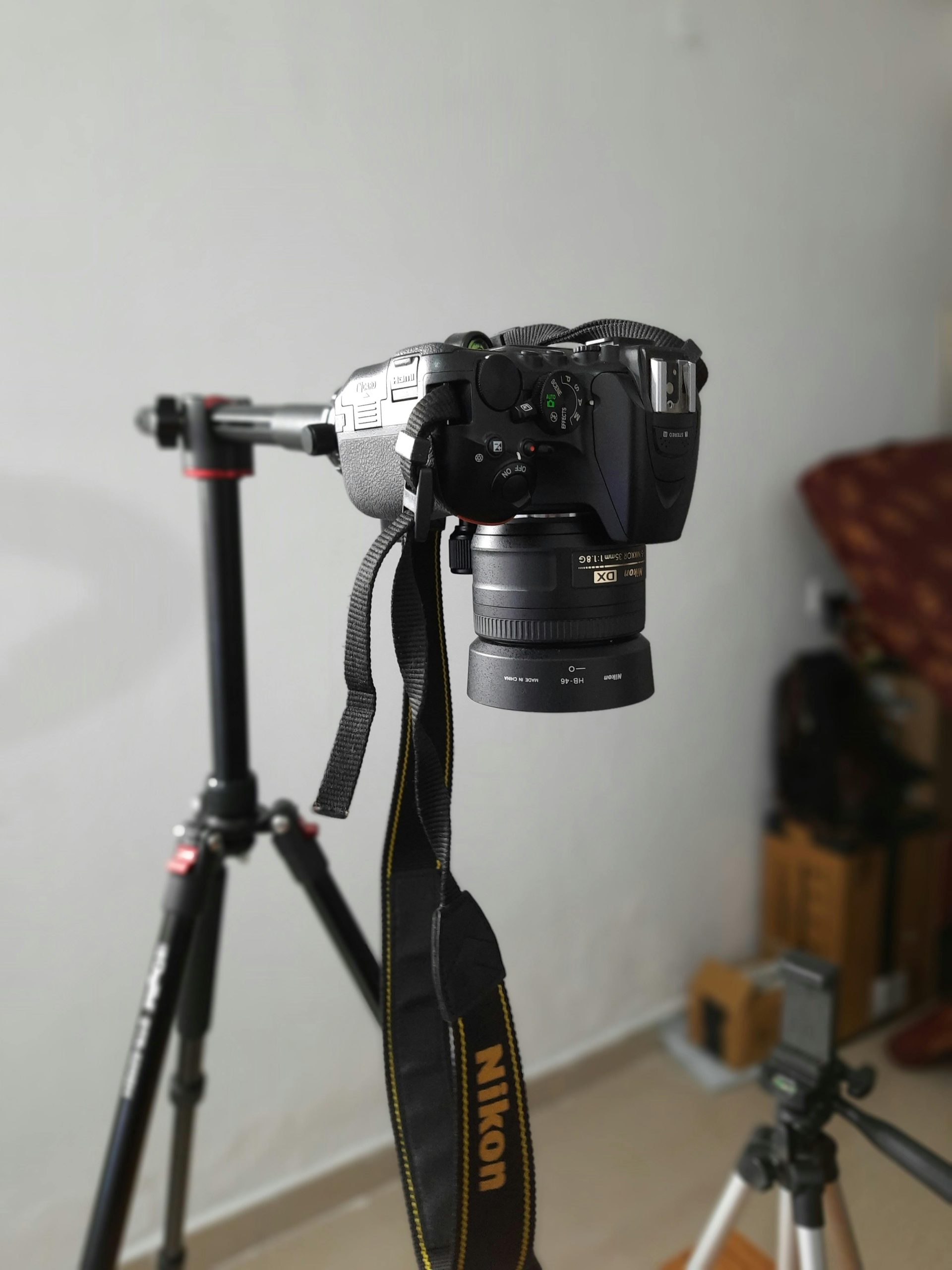 Nikon DSLR camera mounted on tripod in indoor studio setting